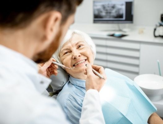 Dentist treating older dental patient