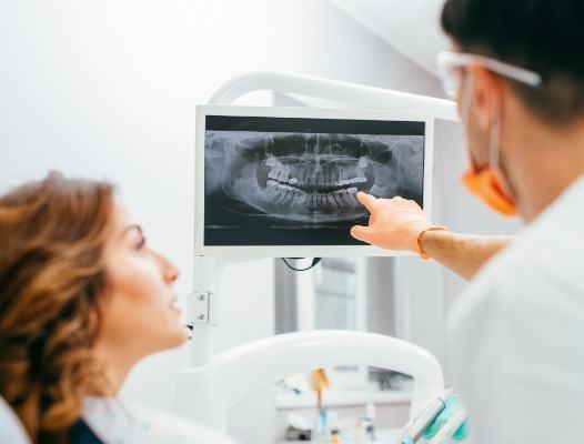 Dentist and patient reviewing digital x-rays during dental checkup