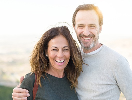 Man and woman with dental implants in Phoenix