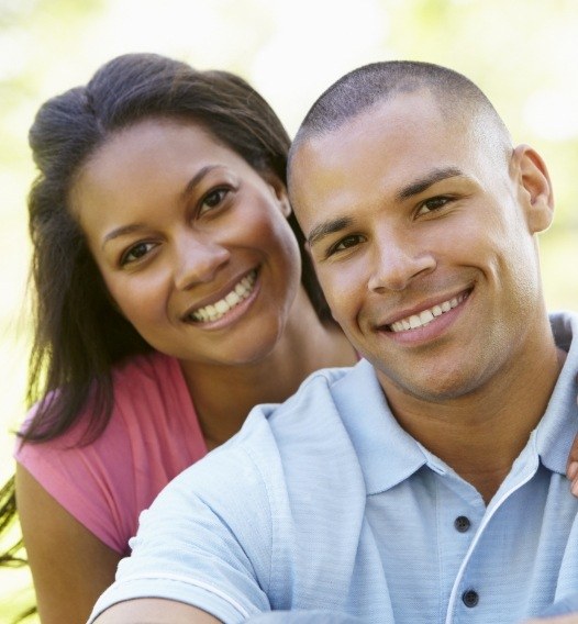 Man and woman smiling after visiting their dental insurance dentist