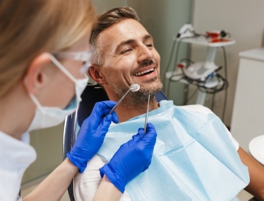 Dentist examining patient's smile