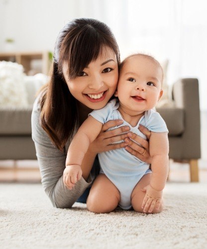 Mother holding baby after children's dentistry visit